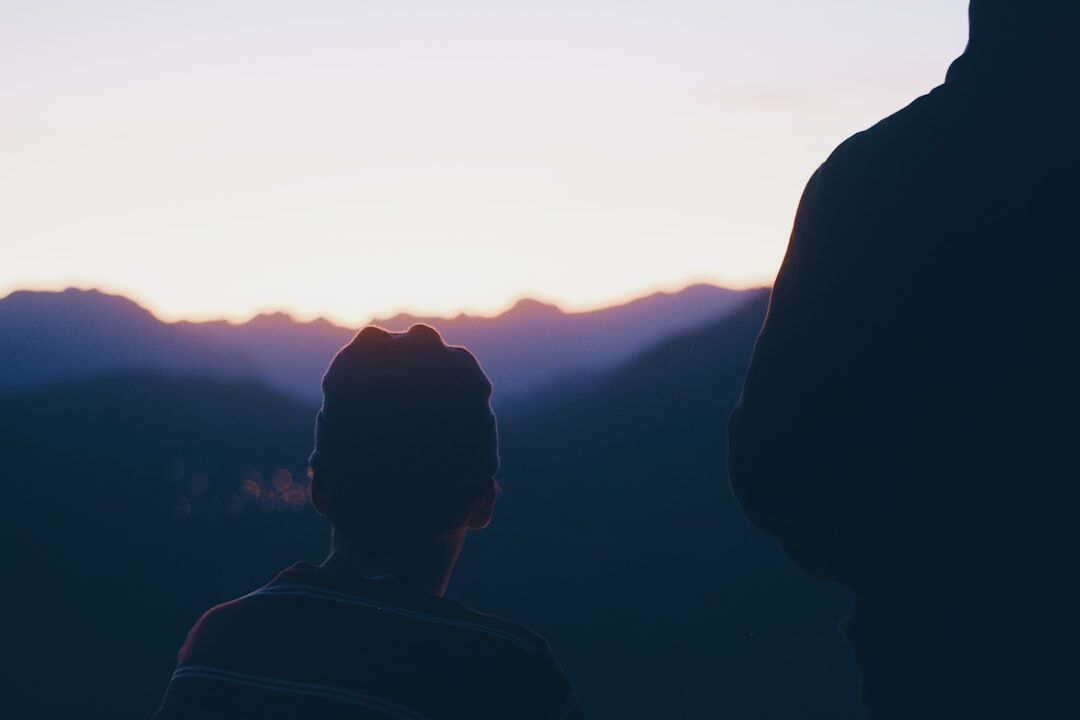 person meditating at sunrise