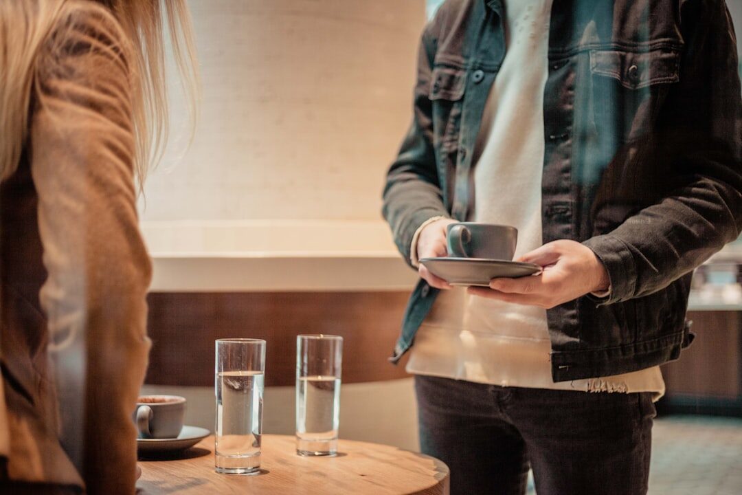 Two people having a warm conversation over coffee at a table