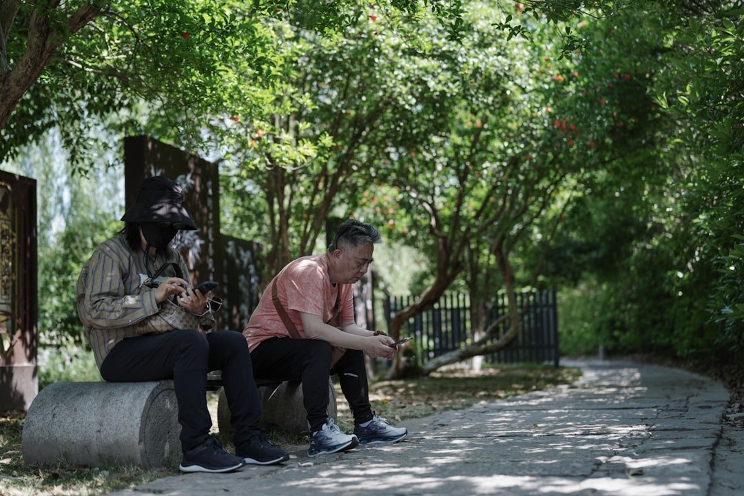 two friends talking on bench