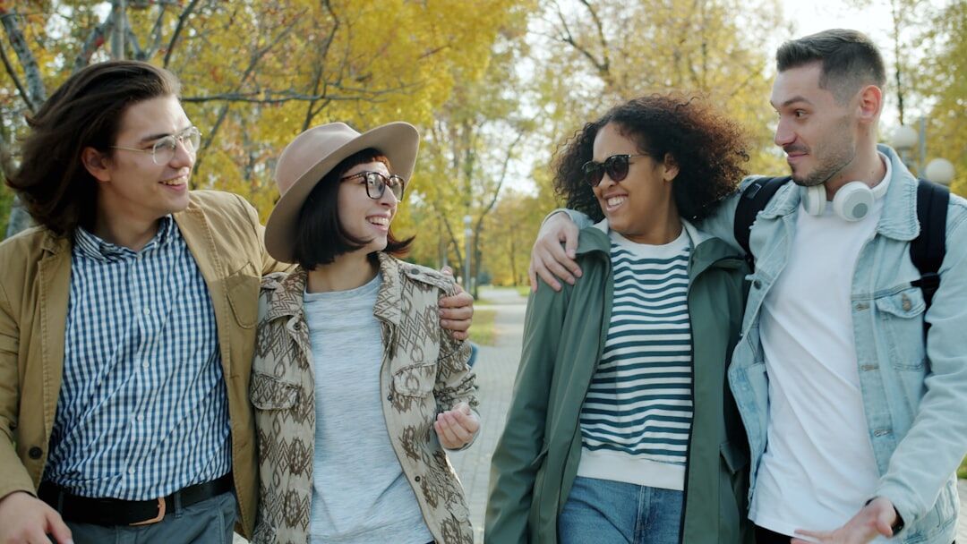 Small group of adults talking outdoors in a park